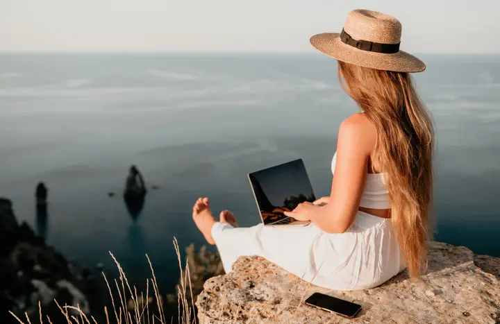 Digital nomad working by the sea